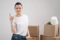 A young beautiful brunette girl in a white T-shirt holds in her hands the keys to a new home, against the background of Royalty Free Stock Photo