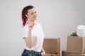 A young beautiful brunette girl in a white T-shirt holds in her hands the keys to a new home, against the background of Royalty Free Stock Photo