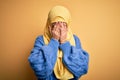 Young beautiful brunette muslim woman wearing arab hijab over isolated yellow background with sad expression covering face with Royalty Free Stock Photo