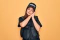 Young beautiful brunette policewoman wearing police uniform bulletproof and cap sleeping tired dreaming and posing with hands Royalty Free Stock Photo