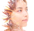 A young beautiful brunette`s double exposure profile portrait combined with a photo of colorful tropical foliage Royalty Free Stock Photo