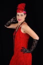 Young beautiful brunette in 1920 style attire red dress and a fe