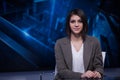 Young beautiful brunette television announcer at studio during live broadcasting.Female TV director at editor in studio. Royalty Free Stock Photo