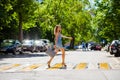 Young beautiful woman in a blue short dress walking on the road Royalty Free Stock Photo