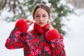 Young beautiful brunette woman in fur coat posing on winter park Royalty Free Stock Photo