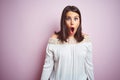 Young beautiful brunette woman over pink isolated background afraid and shocked with surprise expression, fear and excited face Royalty Free Stock Photo