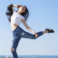 Young beautiful brunette woman posing against blue sky bright sunny weather Royalty Free Stock Photo