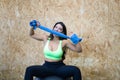 Young and beautiful brunette woman resting sitting on the ball in the gym. She shows her towel to the camera and does different Royalty Free Stock Photo