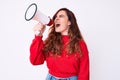 Young beautiful brunette woman screaming using megaphone over isolated white background Royalty Free Stock Photo