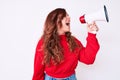 Young beautiful brunette woman screaming using megaphone over isolated white background Royalty Free Stock Photo