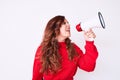 Young beautiful brunette woman screaming using megaphone over isolated white background Royalty Free Stock Photo