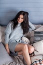Young beautiful brunette woman sitting home on the sofa Royalty Free Stock Photo