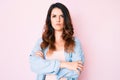 Young beautiful brunette woman wearing casual clothes over pink background skeptic and nervous, disapproving expression on face Royalty Free Stock Photo