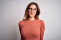 Young beautiful brunette woman wearing casual sweater and glasses over white background smiling looking to the side and staring Royalty Free Stock Photo