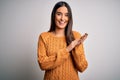 Young beautiful brunette woman wearing casual sweater over isolated white background clapping and applauding happy and joyful, Royalty Free Stock Photo