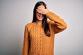 Young beautiful brunette woman wearing casual sweater over isolated white background smiling and laughing with hand on face Royalty Free Stock Photo