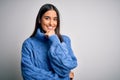 Young beautiful brunette woman wearing casual turtleneck sweater over white background looking confident at the camera smiling Royalty Free Stock Photo