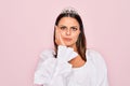 Young beautiful brunette woman wearing princess tiara standing over isolated pink background thinking looking tired and bored with