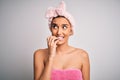 Young beautiful brunette woman wearing towel after shower over isolated white background looking stressed and nervous with hands Royalty Free Stock Photo