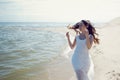 Young beautiful brunette woman in white dress on the seashore Royalty Free Stock Photo