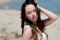 Young beautiful brunette woman in white dress on the seashore. portrait with closed eyes Royalty Free Stock Photo