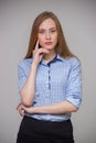 Young beautiful business woman in a blue shirt stands with her a Royalty Free Stock Photo