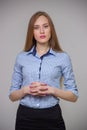 Young beautiful business woman in a blue shirt stands with her a Royalty Free Stock Photo