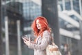 Young beautiful business woman holding tablet, working in downtown, outdoors Royalty Free Stock Photo