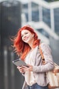 Young beautiful business woman holding tablet, working in downtown, outdoors Royalty Free Stock Photo