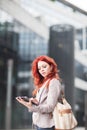 Young beautiful business woman holding tablet, working in downtown, outdoors Royalty Free Stock Photo