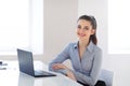 Young beautiful business woman with laptop in the office Royalty Free Stock Photo