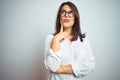 Young beautiful business woman wearing glasses over isolated background with hand on chin thinking about question, pensive Royalty Free Stock Photo