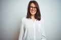 Young beautiful business woman wearing glasses over isolated background with a happy and cool smile on face Royalty Free Stock Photo