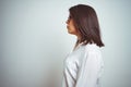 Young beautiful business woman wearing glasses over isolated background looking to side, relax profile pose with natural face with Royalty Free Stock Photo