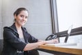 Young beautiful business woman wearing suit sitting on chair with laptop Royalty Free Stock Photo