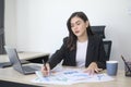 Young beautiful business woman working on laptop with documents in modern office Royalty Free Stock Photo