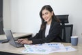 Young beautiful business woman working on laptop with documents in modern office Royalty Free Stock Photo