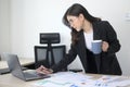 Young beautiful business woman working on laptop with documents in modern office Royalty Free Stock Photo