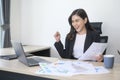 Young beautiful business woman working on laptop with documents in modern office Royalty Free Stock Photo