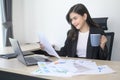 Young beautiful business woman working on laptop with documents in modern office Royalty Free Stock Photo