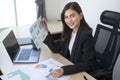 Young beautiful business woman working on laptop with documents in modern office Royalty Free Stock Photo