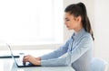 Young beautiful business woman working on laptop in the office Royalty Free Stock Photo