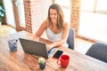 Young beautiful business woman working using laptop at home or the office, smiling positive Royalty Free Stock Photo