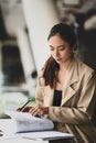 Young beautiful businesswoman concentrate on her project in office room.