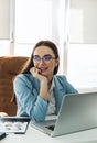 Young beautiful businesswoman in glasses working on laptop Royalty Free Stock Photo