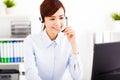 Young beautiful businesswoman with headset in office Royalty Free Stock Photo