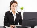 Young beautiful businesswoman with headset in office Royalty Free Stock Photo