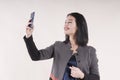 Young beautiful businesswoman portrait cheerful phone smiling braces studio, making selfie Royalty Free Stock Photo