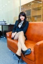 Young beautiful businesswoman resting lying on a sofa in office