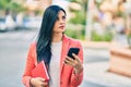 Young beautiful businesswoman with serious expression using smartphone at the city Royalty Free Stock Photo